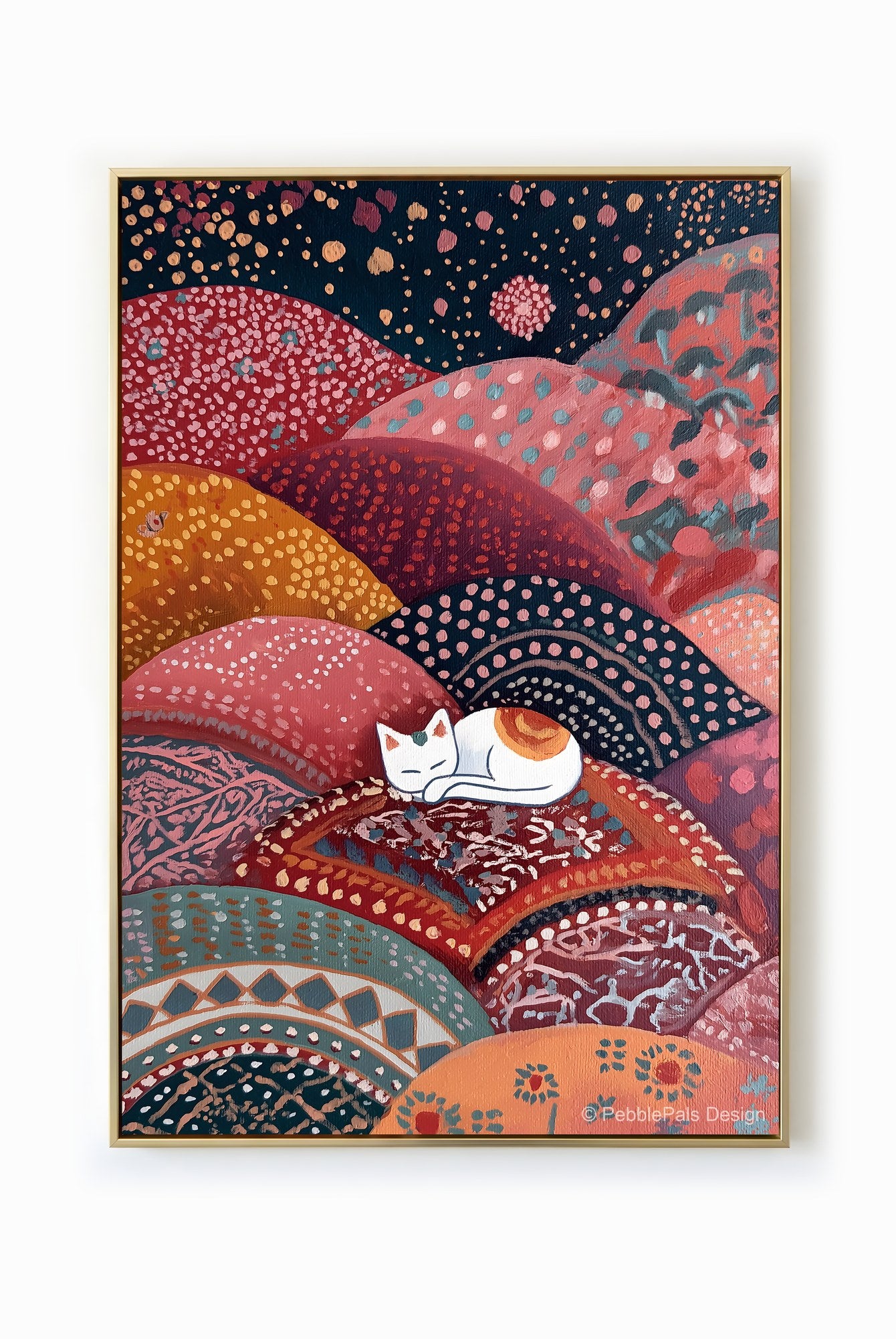A folk art painting of a white cat sleeping peacefully on colorful, patterned hills.
