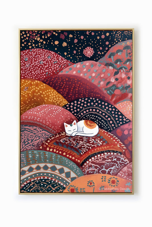 A folk art painting of a white cat sleeping peacefully on colorful, patterned hills.